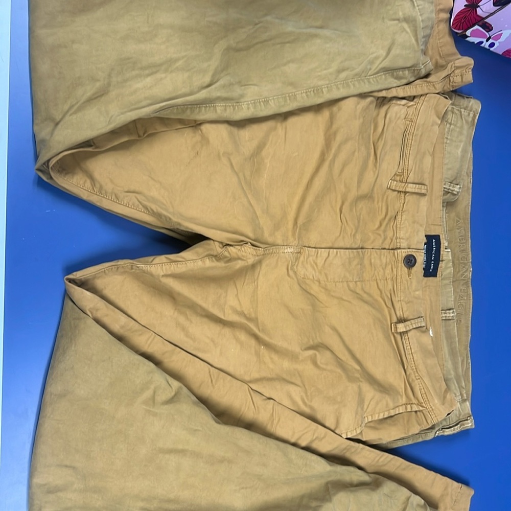Two pairs of men’s American eagle next flex chinos